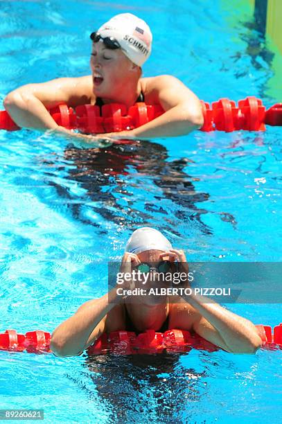 Italy's Federica Pellegrini and US Allison Schmitt react after the Women's 400m freestyle on July 26, 2009 at the 13th FINA World Swimming...