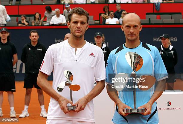 Nikolay Davydenko of Russia and Paul Henri Mathieu of France poses with the trophy during day seven of the International German Open at Rothenbaum...