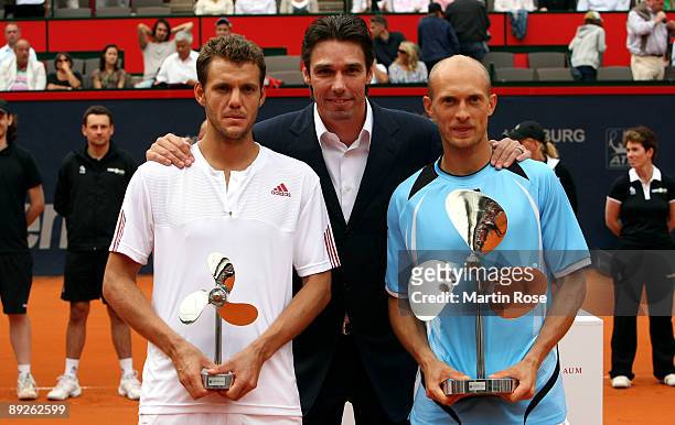 Tournament director Michael Stich poses with Nikolay Davydenko of Russia and Paul Henri Mathieu of France for a photo during day seven of the...