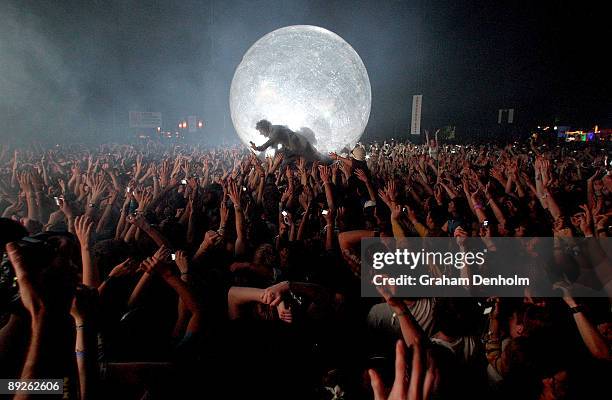 Wayne Coyne of the Flaming Lips climbs into the crowd in a large inflatable ball during the Splendour in the Grass festival at Belongil Fields on...