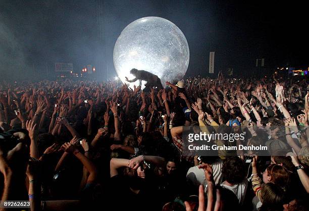 Wayne Coyne of the Flaming Lips climbs into the crowd in a large inflatable ball during the Splendour in the Grass festival at Belongil Fields on...