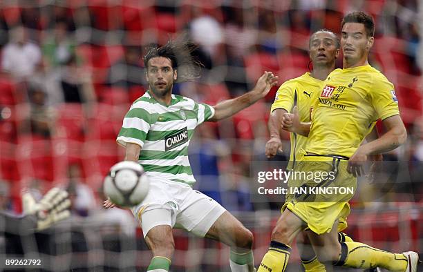 Celtic's Greek player Georgios Samaras scores his goal watched by Tottenham Hotspur's Dorian Dervite and Tottenham Hotspurs Cameroon player Benoit...