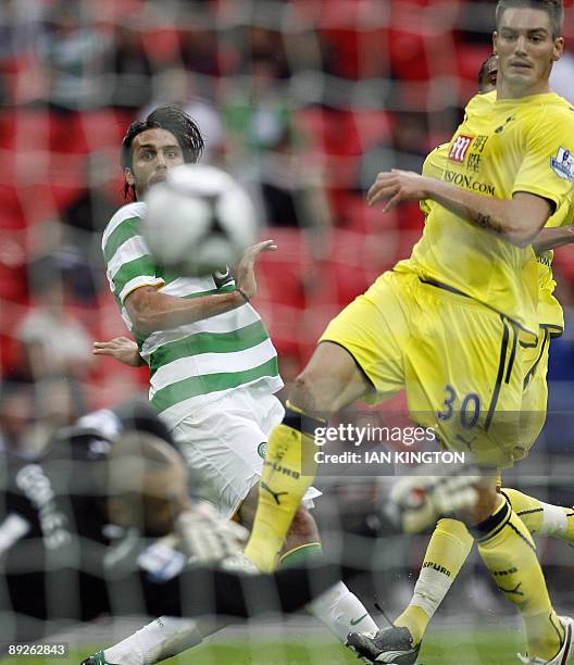 Celtic's Greek player Georgios Samaras scores his goal watched by Tottenham Hotspur's Dorian Dervite during the Wembley Cup competition at Wembley...