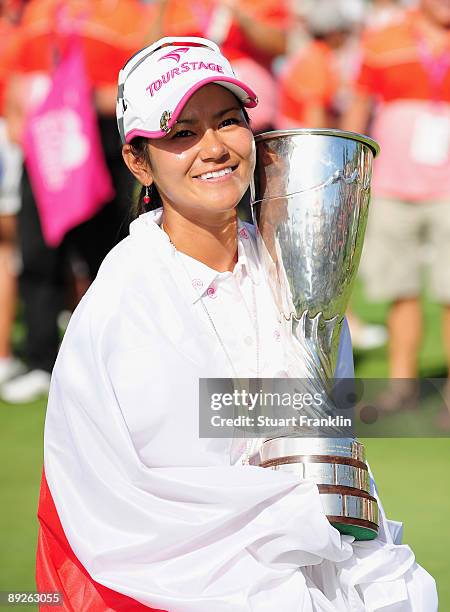 Ai Miyazato of Japan poses with the winners trophy after winning in a playoff against Sofie Gustafson of Sweden after the final round of the Evian...