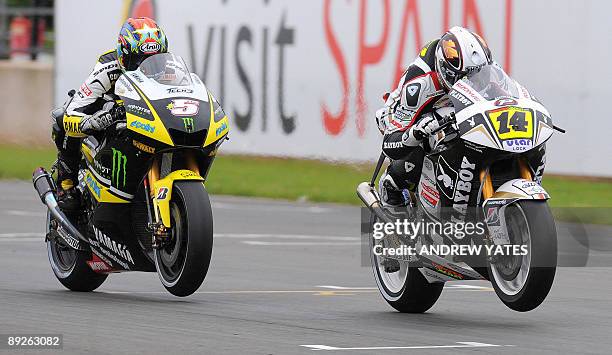 Randy De Puniet of France is followed by Colin Edwards of the United States during the British Grand Prix at Donington Park, in Leicestershire,...