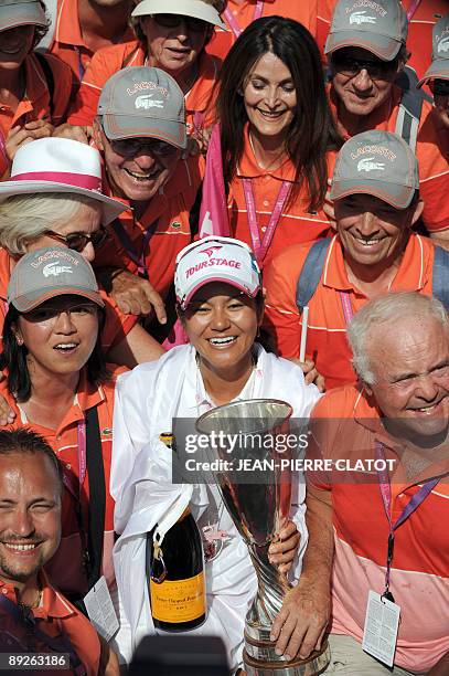 Japanese Ai Miyazato poses with volunteers after winning the Evian Masters Golf Tournament, on July 26, 2009 in Evian-les-Bains, central-eastern...