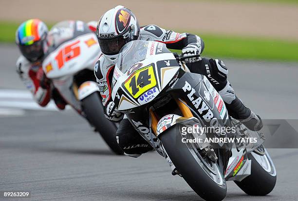 Randy De Puniet of France leads Alex De Angelis of San Marino at Donington Park, in Leicestershire, central England, on July 26, 2009. Andrea...