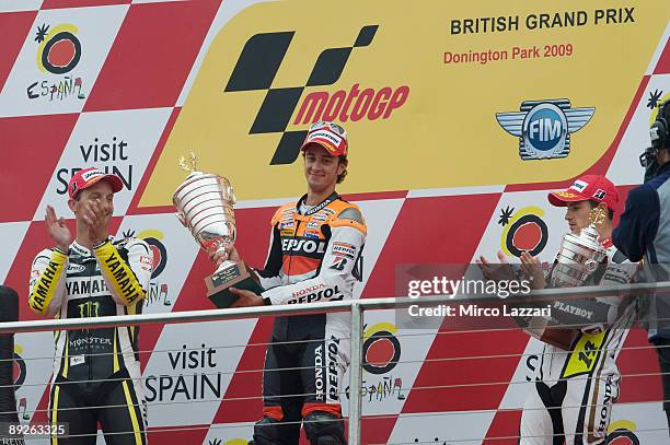 Andrea Dovizioso of Italy and Repsol Honda and Colin Edwards of USA and Monster Yamaha Tech 3 and Randy De Puniet of France and LCR Honda celebrate...