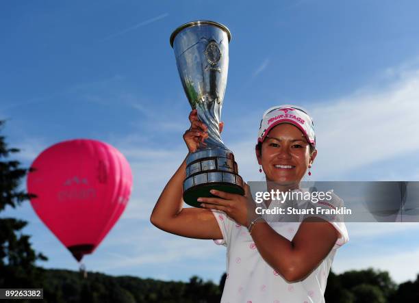 Ai Miyazato of Japan poses with the winners trophy after winning in a playoff against Sofie Gustafson of Sweden during the final round of the Evian...