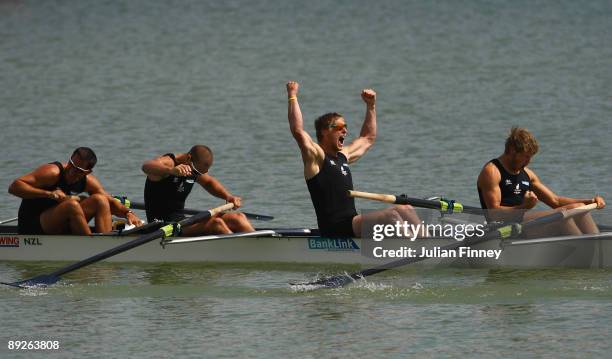 Jade Uru, Simon Watson, Hamish Burson and Tyson Williams of New Zealand celebrate winning gold after the Mens Four Final during day four of the FISA...