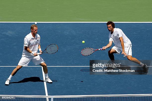 Ernests Gulbis of Latvia returns a shot to Ashley Fisher and Jordan Kerrwhile playing with Dmitry Tursunov of Russia during the doubles final of the...