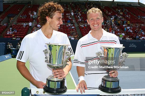 Ernests Gulbis of Latvia and Dmitry Tursunov of Russia pose for photographers after defeating Ashley Fisher and Jordan Kerr during the doubles final...