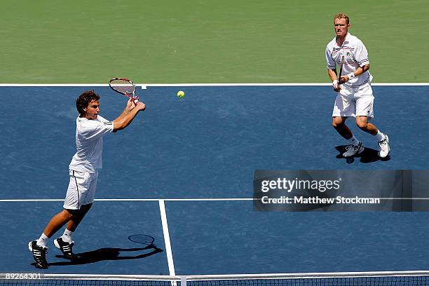 Ernests Gulbis of Latvia returns a shot to Ashley Fisher and Jordan Kerrwhile playing with Dmitry Tursunov of Russia during the doubles final of the...