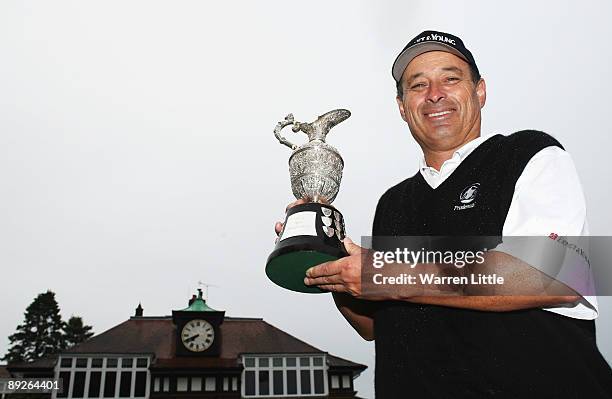 Loren Roberts of the USA poses with the trophy after winning The Senior Open Championship presented by MasterCard after three-way three hole play-off...