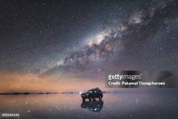 milky way across uyuni, bolivia - land vehicle stock pictures, royalty-free photos & images