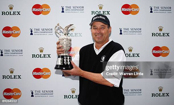 Loren Roberts of the USA poses with the trophy after winning The Senior Open Championship presented by MasterCard after three-way three hole play-off...