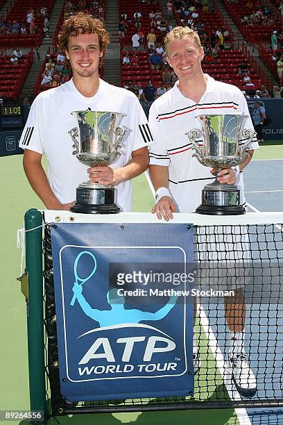 Ernests Gulbis of Latvia and Dmitry Tursunov of Russia pose for photographers after defeating Ashley Fisher and Jordan Kerr during the doubles final...