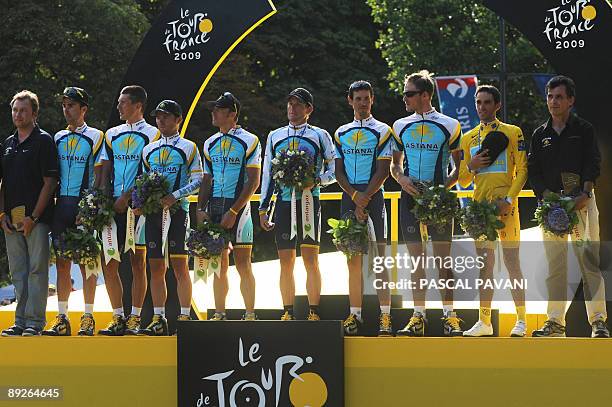 The winner of 2009 Tour de France cycling race, Kazakh cycling team Astana 's leader Alberto Contador of Spain poses with teammates and Tour de...