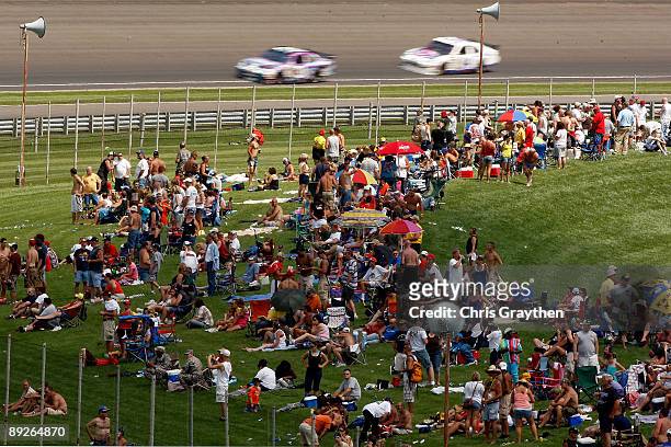 Fans sit in the infield during the NASCAR Sprint Cup Series Allstate 400 at the Brickyard at Indianapolis Motor Speedway on July 26, 2009 in...