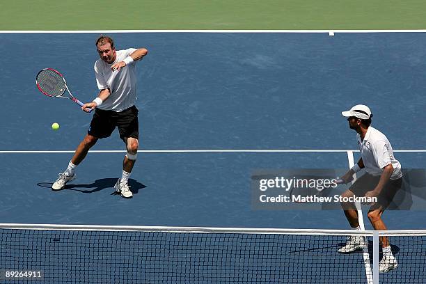 Ashley Fisher of Australia returns a shot to Ernests Gulbis of Latvia Dmitry Tursunov of Russia while playing with Jordan Kerr of Australia during...