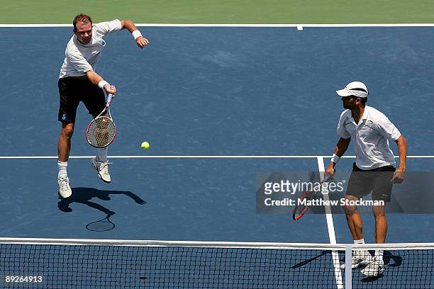 Ashley Fisher of Australia returns a shot to Ernests Gulbis of Latvia Dmitry Tursunov of Russia while playing with Jordan Kerr of Australia during...