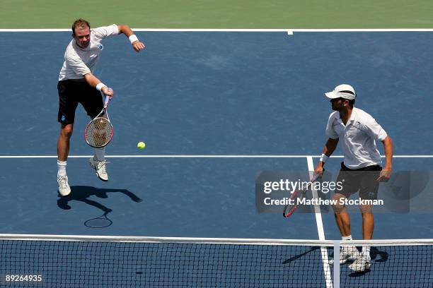 Ashley Fisher of Australia returns a shot to Ernests Gulbis of Latvia Dmitry Tursunov of Russia while playing with Jordan Kerr of Australia during...