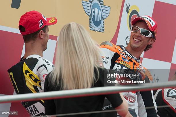 Andrea Dovizioso of Italy and Repsol Honda Team and Colin Edwards of USA and Monster Yamaha Tech 3 celebrate on the podium after the MotoGp race of...