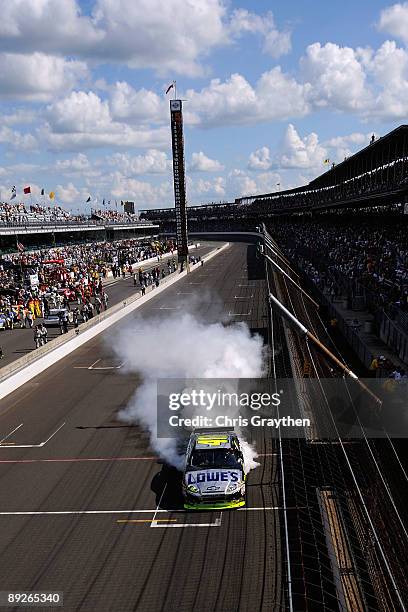 Jimmie Johnson, driver of the Lowe's/KOBALT Tools Chevrolet, burns out after winning the NASCAR Sprint Cup Series Allstate 400 at the Brickyard at...