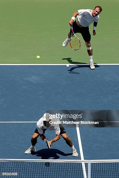 Ashley Fisher of Australia serves to Ernests Gulbis of Latvia Dmitry Tursunov of Russia while playing with Jordan Kerr of Australia during the...