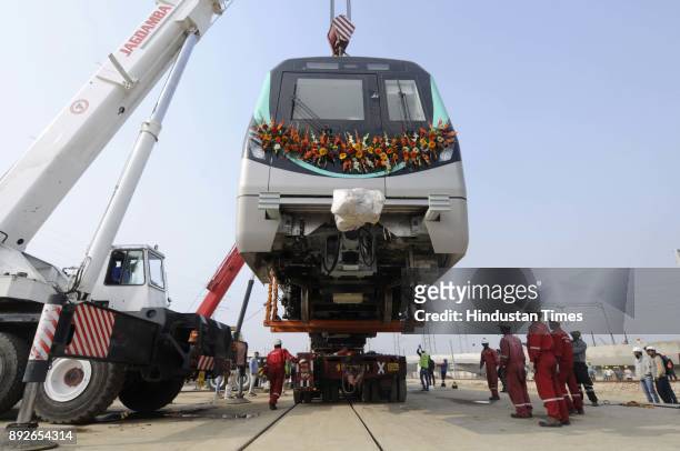 New Metro coach being lifted by crane to be placed on the track on December 14, 2017 in Greater Noida, India. Four Metro coaches have been delivered...