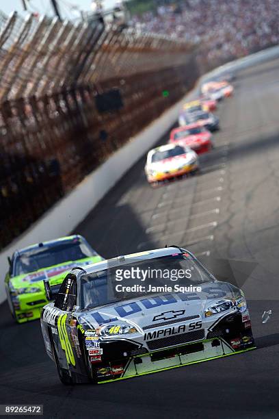 Jimmie Johnson, driver of the Lowe's/KOBALT Tools Chevrolet, drives in front of Mark Martin, driver of the CARQUEST/Kellogg's Chevrolet, before...