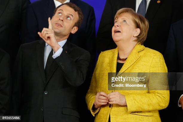 Emmanuel Macron, France's president, left, and Angela Merkel, Germany's chancellor, react during a Permanent Structured Cooperation in Defence family...