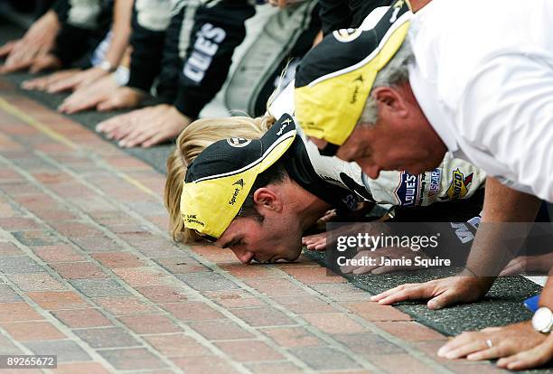 Jimmie Johnson, driver of the Lowe's/KOBALT Tools Chevrolet,celebrates by kissing the bricks after Johnson wins the NASCAR Sprint Cup Series Allstate...