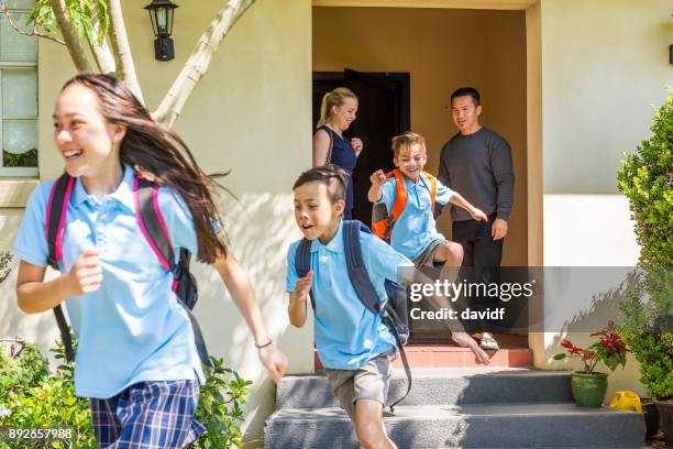 excited school children leaving the house - back to school stock pictures, royalty-free photos & images