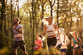 Large group of motivated runners running a marathon in nature.