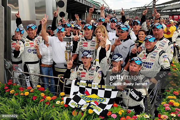 Jimmie Johnson, driver of the Lowe's/KOBALT Tools Chevrolet, celebrates with his team after winning the NASCAR Sprint Cup Series Allstate 400 at the...