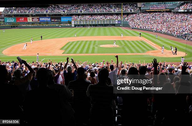 Rockies fans celebrate as relief pitcher Huston Street of the Colorado Rockies strikes out Juan Uribe of the San Francisco Giants for the final out...