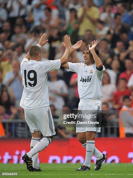 Raul Gonzalez celebrates with Karim Benzema after scoring a goal during the Peace Cup match between Real Madrid and Al-Ittihad at the Santiago...