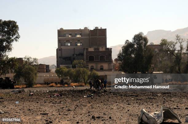 People carry a body of a prisoner after he was killed in airstrikes targeted the prison on December 13, 2017 in Sana’a, Yemen. More than 12 prisoners...