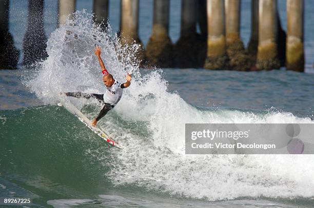 Kelly Slater turns off the top during his Men's Quarterfinal heat against Adriano de Souza during the 2009 Hurley U.S. Open of Surfing on July 26,...