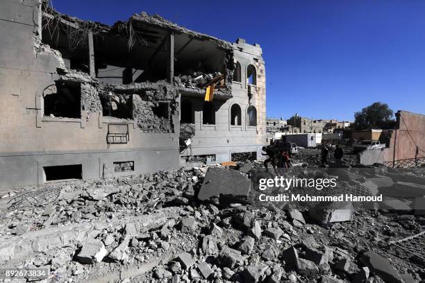 People walk on rubble of a prison after it was hit by airstrikes on December 13, 2017 in Sana’a, Yemen. More than 12 prisoners killed and 80 others...