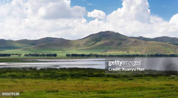 moor landscape with a river and the sun shining through the cloudy sky - watershed 2017 bildbanksfoton och bilder