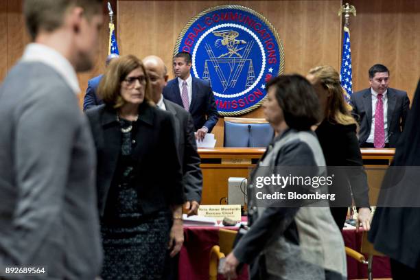 Ajit Pai, chairman of the Federal Communications Commission , center left, stands up during an evacuation of the meeting room at an open commission...