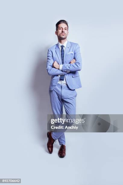 male model posing in blue suit in studio full length - black tie party fancy stock pictures, royalty-free photos & images