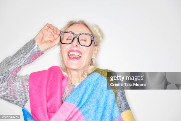 older woman laughing - woman in a shawl stockfoto's en -beelden