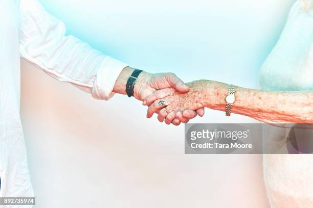 older people shaking hands