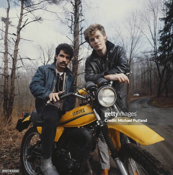 John Oates , sitting on a Yamaha motorbike, and Daryl Hall of American pop duo Hall and Oates, New York State, February 1983.