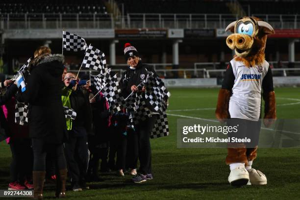 Edgar the Hereford FC Mascot pitchside alongside children with flags ahead of the Emirates FA Cup second round replay match between Hereford FC and...