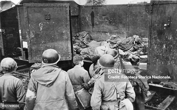 The Allies discovering the horror of the concentration camps. Some prisoners died in a railroad car during a journey, probably to the camp of...