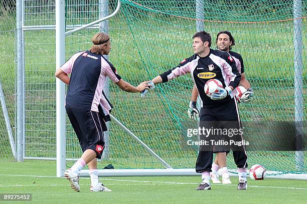 New goalkeeper of Palermo Giacomo Brichetto meets his mates Marco Amelia and Salvatore Sirigu during a training session at Sportarena on July 24,...
